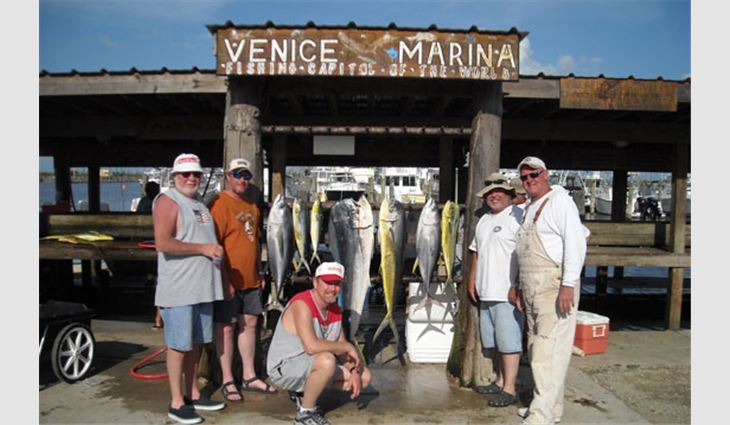 Denton (center) with some friends on a fishing trip to the Louisiana coast