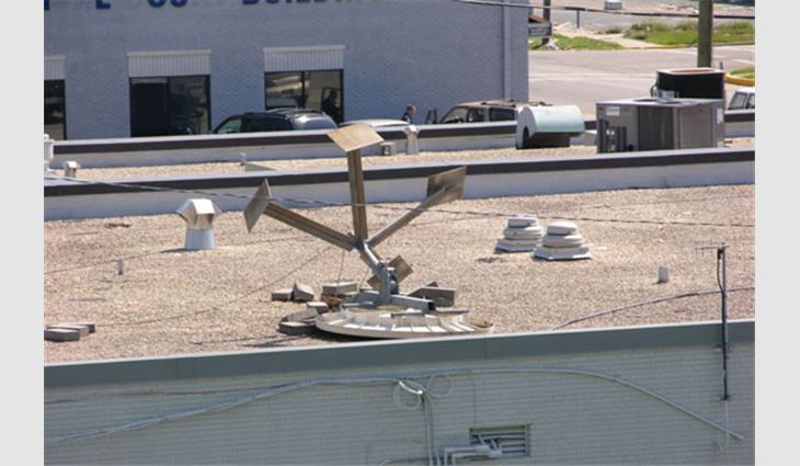This satellite dish simply sat on the roof ballasted with concrete pavers. Wind-blown dishes can tear roof membranes.