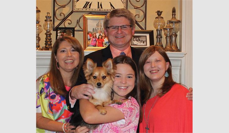 Workman with his wife, Buffy; daughters, Laura and Alicia; and dog, Max