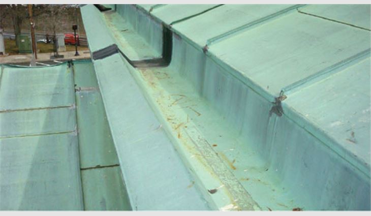 Pictured top to bottom: New 20-ounce double-locked standing-seam copper panels were formed on site; an aerial view of the completed copper roof system
