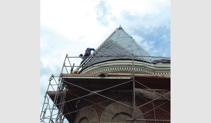 Hilltop Vermont Black slate being installed on a conical roof system