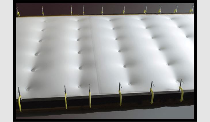 Photo 1: Wind uplift of a membrane with fasteners arranged in a grid pattern