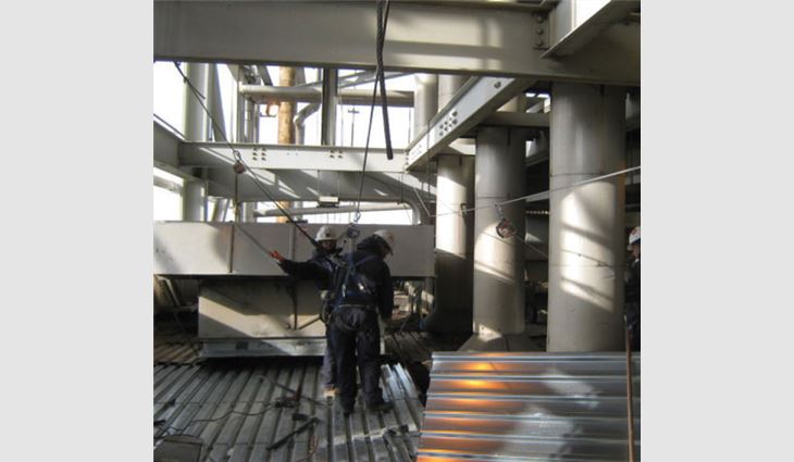 5/8-inch-thick steel cable fall-arrest systems were attached to the main structural support columns and beams