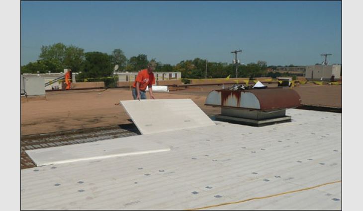 A worker installs high-density EPS insulation boards.