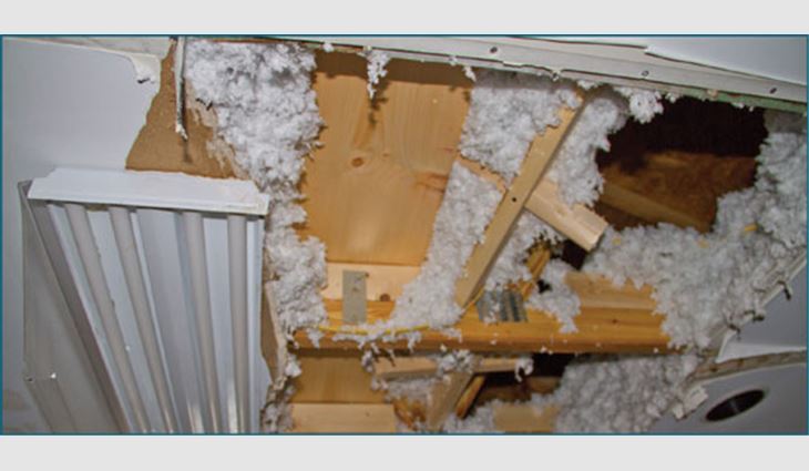Photo 7: Collapsed ceiling in the kitchen on the duplex's unsealed roof deck side 