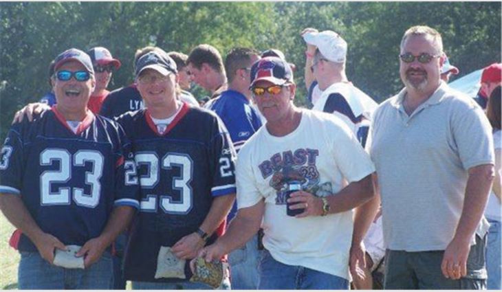 Pastore (left) at a Buffalo Bills game with Upstate Roofing and Painting Chief Operating Officer Bob Morgan, Steep-slope Field Superintendent Rick Gourley, and Maintenance and Repair Manager Todd Johnson