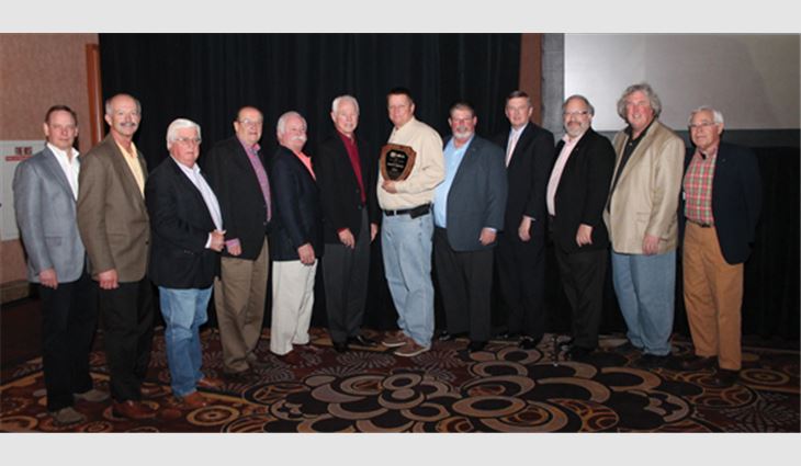 Rob Therrien, president of The Melanson Co. Inc., Keene, N.H., and winner of the 2014 J.A. Piper Award, is surrounded by former Piper Award recipients.