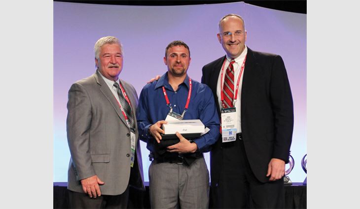 Ryan Watts, foreman for Jurin Roofing Services Inc., Quakertown, Pa., receives the Best of the Best Award from Tim Rainey (left),president of Supreme Systems Inc., Dallas, and Josh Kelly, vice president and general manager of OMG Roofing Products.