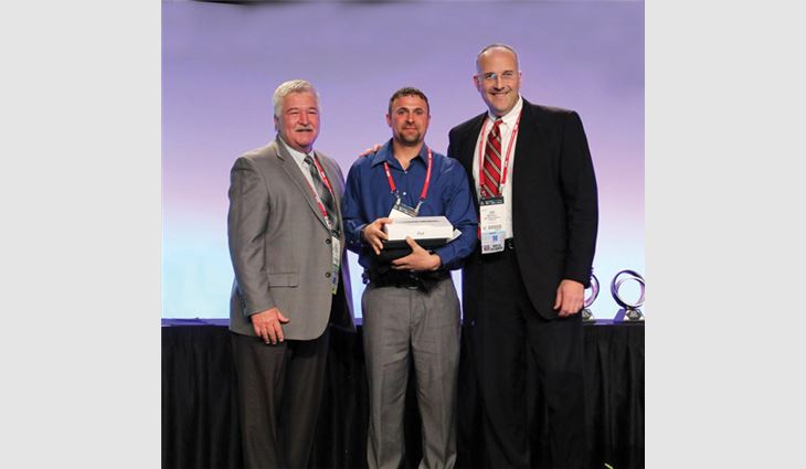 Watts (center) with Tim Rainey (left), MVP Task Force chairman, and Josh Kelly, vice president and manager of OMG Roofing Products Inc., Agawam, Mass., after Watts won the Best of the Best Award