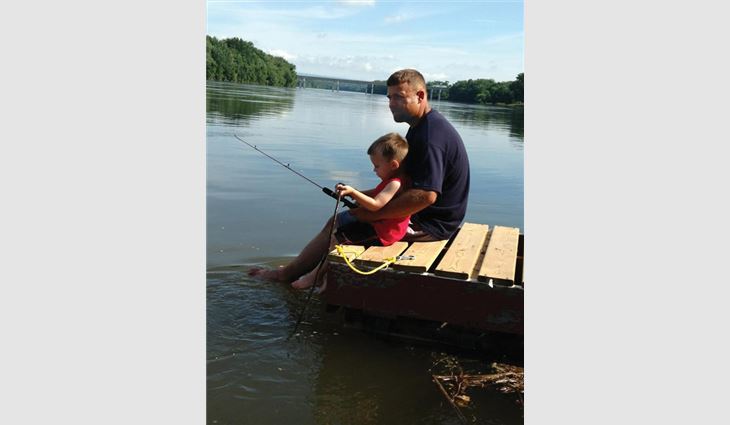 Watts fishing with his son, Bryce