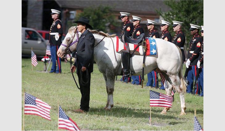 Bill Johnson, chairman and CEO of Johnson Roofing Inc., Waco, Texas, performs the Riderless Horse during Memorial Day ceremonies to honor fallen soldiers.