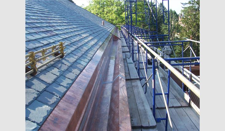 A custom-fabricated 32-ounce cold-rolled copper riveted and soldered two-piece gutter system was installed on the main roof.