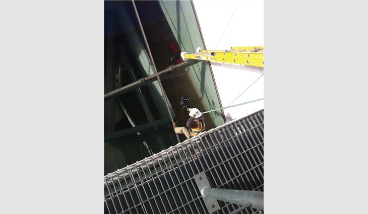 To access the cantilevered escalator structure, workers used suction cups to climb the glass surface and then repelled down the 30-degree slope roof.