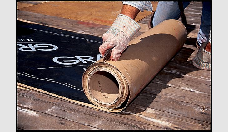 Step one of the conventional underlayment installation method: Cut the membrane into 10- to 15-foot lengths and reroll loosely, then peel back 1 to 2 feet of release liner and align the membrane.