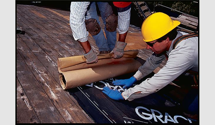 Step five of the back-roll underlayment installation method: Stop frequently to press the membrane in place with heavy hand pressure, smoothing the membrane toward the outer edge.