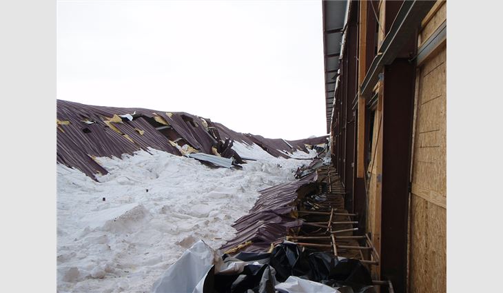 A collapsed roof over an agricultural building that was the result of drifting snow in Minnesota