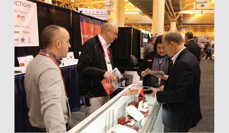 Visitors to ROOFPAC's booth bid on auction items.