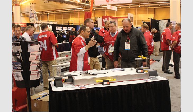 Expo attendees listen to a product demonstration. 