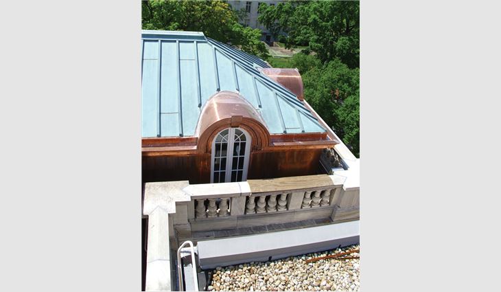 Work on the library included upper and lower built-in gutters, copper wall cladding, cornices between dormers, 26 radius eyebrow dormer cornices, barrel roof covers, and new historically accurate windows and framing.