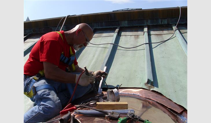 Custom-fabricated copper roof systems were installed on top of the barrel dormers.