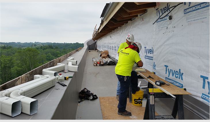 TruCraft Roofing workers install the ark's gutters and edge metal