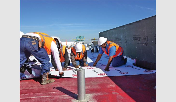 Purvis works on the roof of a State Farm building in Plano, Texas.