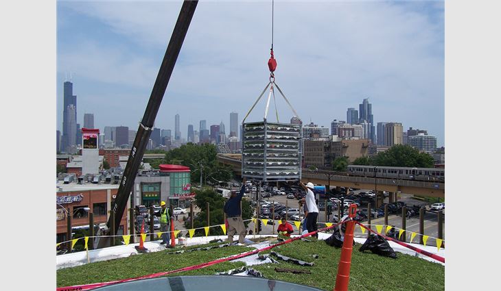 A crane was used to hoist roofing materials.