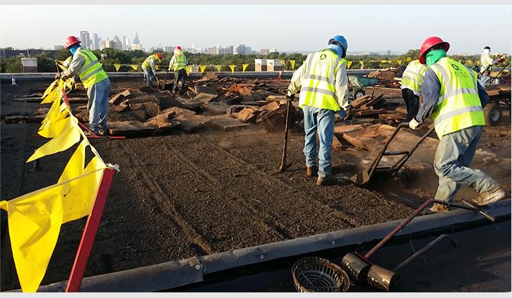 Castro Roofing workers remove an existing coal-tar pitch roof system from a 102,600-square-foot area.