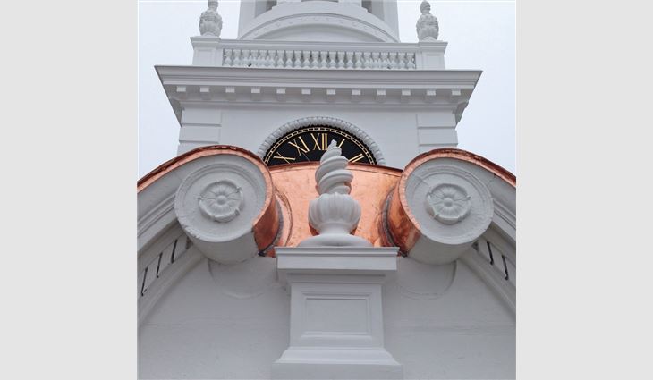 Newly restored clock and copper radiused dormers.