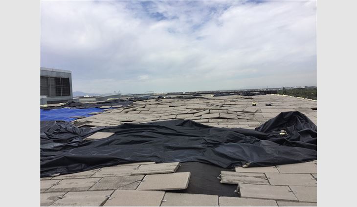 A microburst lifted the EPDM membrane and pavers, resulting in significant damage.