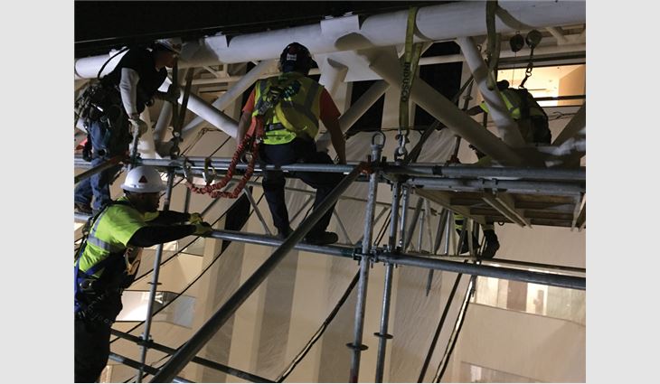 The engineered scaffolding system was suspended from the atrium's space frame with beam straps and chains.