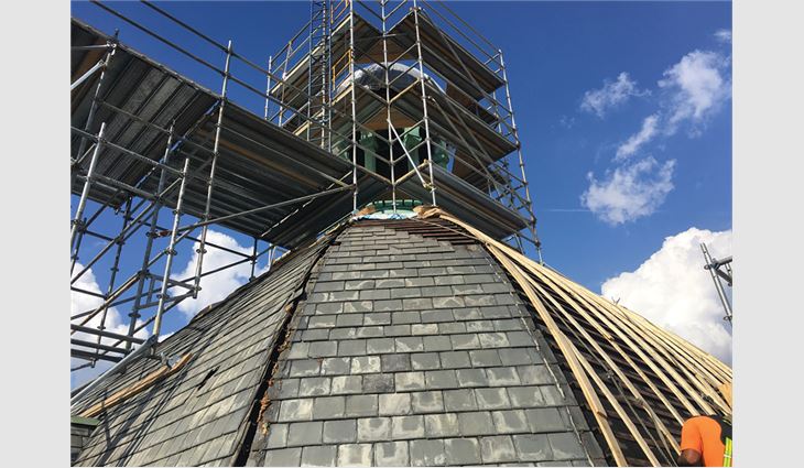 After removing the slate on the dome, American Roofing and Metal workers installed wood lathe strips vertically and three layers of 3/8-inch-thick plywood before applying underlayment and installing slate.