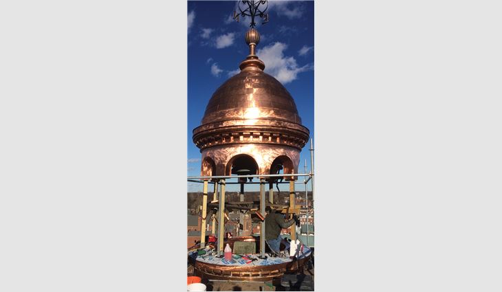 A full-scale replica of the cupola base was built in Steinrock Roofing and Sheet Metal's fabrication shop. Workers clad the cupola with soft copper in flat-locked panels. More than 10,700 pounds of copper were used on the project.