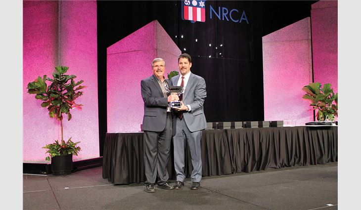 NRCA Chairman of the Board-Elect Nick Sabino (right) presented the Charlie Raymond Award to Jim Slauson, vice president of GM specialty products for GAF, Parsippany, N.J.