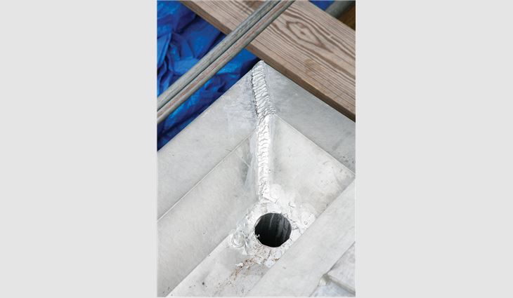 Ruff Roofers craftsmen added a new taper to facilitate proper drainage to the gable roof’s front built-in gutter, requiring each piece to be custom-fabricated. 
