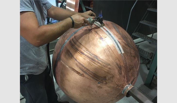 Mahan Slate Roofing workers restored Baker Tower’s weathervane, including the 3-foot-tall copper ball, to original condition.