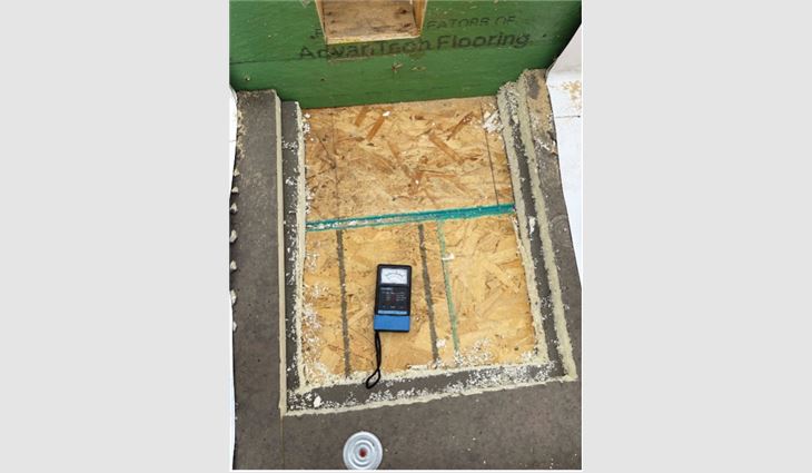 A view of an opening into a warm roof in a northern climate with an oriented strand board roof deck and ductwork below and no insulation below the roof deck. The OSB is in pristine condition and should function for the life of the building.   