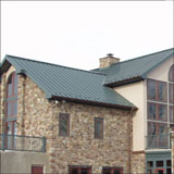 A good match - Donald B. Smith Roofing Inc. installs a metal roof system on a stone home